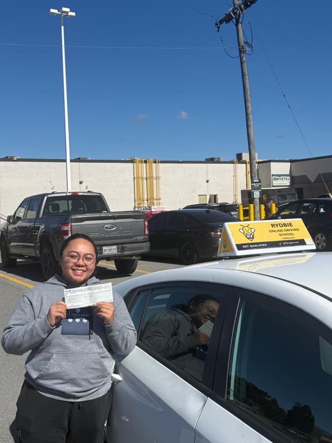 A Rydbie student outside a DriveTest centre holding their new Ontario licence